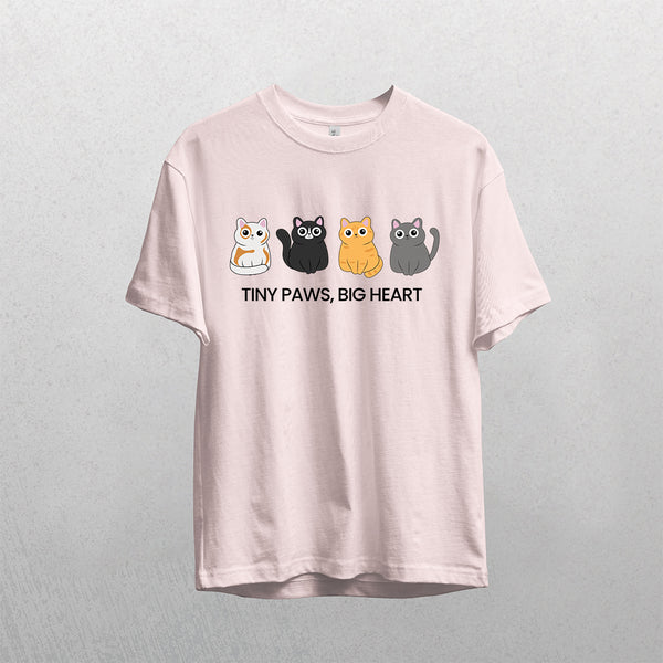 A pink vintage pet t-shirt called Tiny Paws, Big Heart features four colorful cartoon cats above its name. Displayed against a textured background, it’s an ideal gift for pet lovers.
