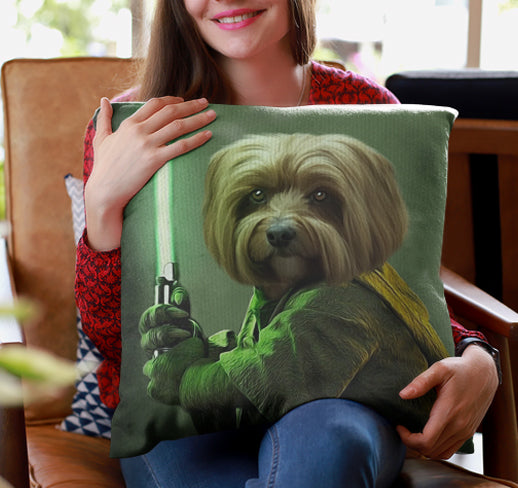 A woman smiles while sitting on a chair, holding the Custom Star Wars Pet Cushion featuring her dog illustrated as a Jedi with a green lightsaber.