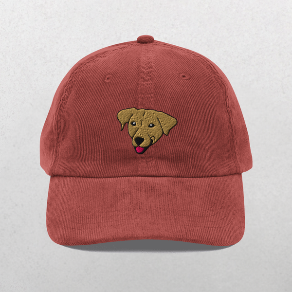 The Custom Pet Portrait Corduroy Cap – Embroidered Pet Hat in burgundy features an embroidered dogs head with its tongue out on the front panel. This custom cap makes a perfect personalized pet gift. The background is plain light gray.