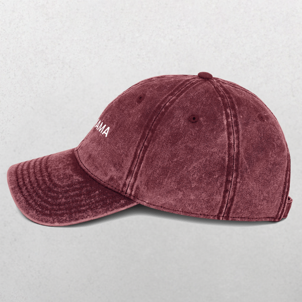 A maroon washed cotton Vintage Cap - Fur Mama features visible stitching, a curved brim, and an adjustable strap. Shown side view on light gray with partial white text—ideal as a pet slogan hat or dog mom gift.