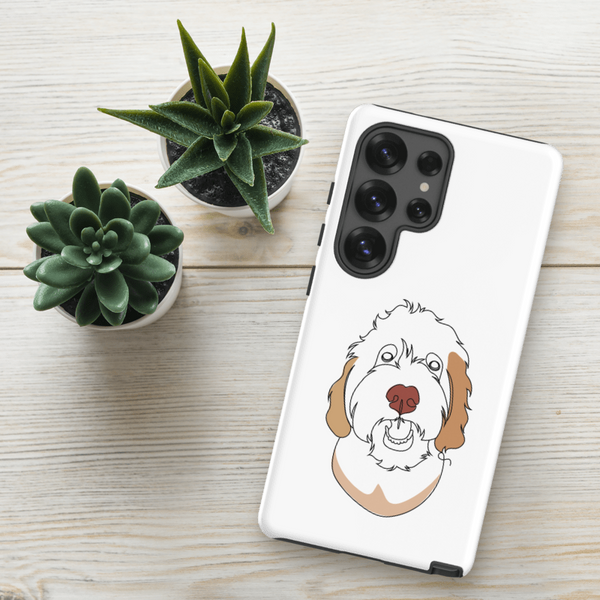 A Custom Pet Samsung Case – Color Line Art, featuring a simple dog line drawing, rests on a light wooden surface beside two small potted succulents.