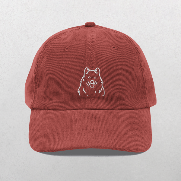 The Custom Pet Line Art Portrait Corduroy Cap – Embroidered Pet Hat in burgundy features a simple white outline of a dog’s face on the front, making it a unique keepsake for pet lovers. Shown against a light gray, textured background.