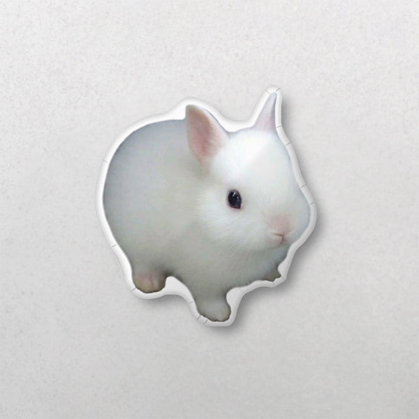 A custom shape pet pillow featuring a small, fluffy white bunny with upright ears on a light grey surface—an adorable gift for pet lovers or a unique pet memorial keepsake.
