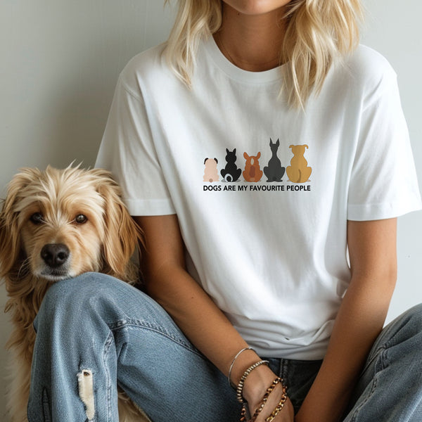 Wearing the Dogs are my Favorite People t-shirt featuring dog silhouettes, someone sits on the floor beside a wavy-furred light brown dog—an ideal gift for any pet lover.