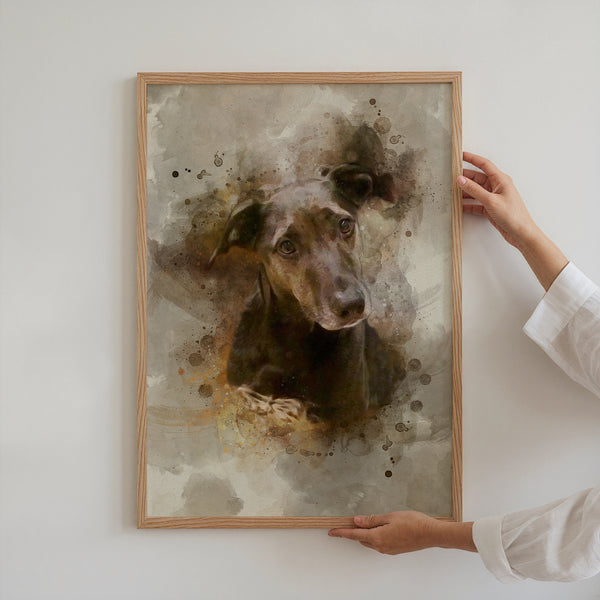A person hangs a Watercolor Pet Portrait—a framed painting of a black dog with expressive eyes and a tilted head—on a light-colored wall.