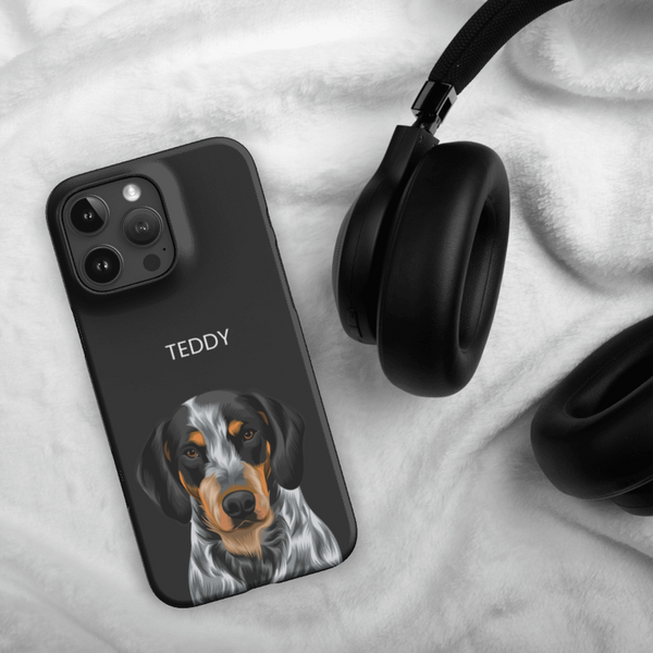 A Custom Pet iPhone Case – Modern Vector Art with a lifelike dog illustration and the name TEDDY rests on a white blanket beside black over-ear headphones—a unique keepsake for any pet lover.