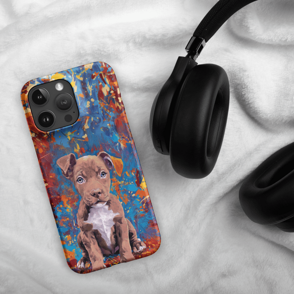 A Custom Pet iPhone Case - Oil Painting with a brown puppy design rests next to black over-ear headphones on a soft white fabric surface.