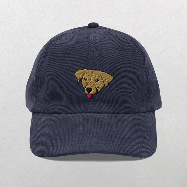 The Custom Pet Portrait Corduroy Cap in navy features an embroidered brown dogs head with its tongue out, centered on the front—a unique keepsake hat for any dog lover.