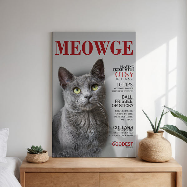 The Custom Pet Magazine Covers framed poster resembles a magazine titled MEOWGE, featuring a gray cat with green eyes. This playful pet lover gift is shown above a white bed, beside potted plants on a wooden nightstand.
