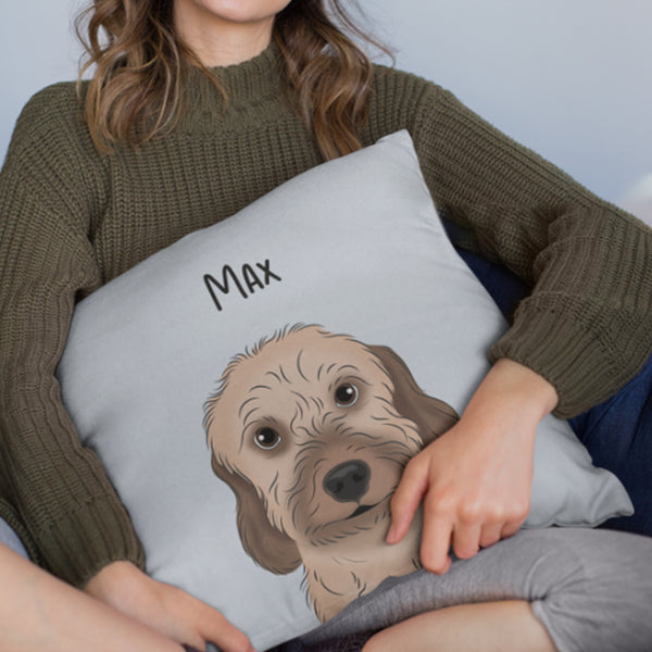 A person in a green sweater holds a Custom Cartoon Pet Cushion showcasing an illustrated dog with the name Max written above the artwork.