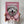 A person holds a Chanel Fashion Cover poster featuring pet artwork of a fluffy white dog in a pink coat and hat, set against a pink background with the word CHANNEL at the top, resembling a fashion magazine cover.