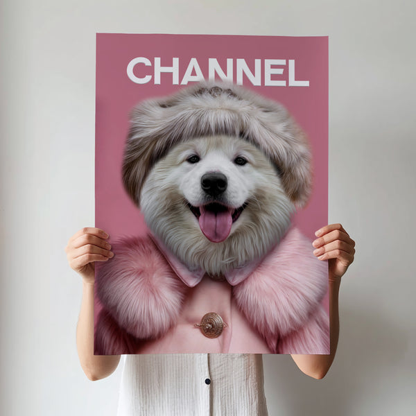 A person holds a Chanel Fashion Cover poster featuring pet artwork of a fluffy white dog in a pink coat and hat, set against a pink background with the word CHANNEL at the top, resembling a fashion magazine cover.