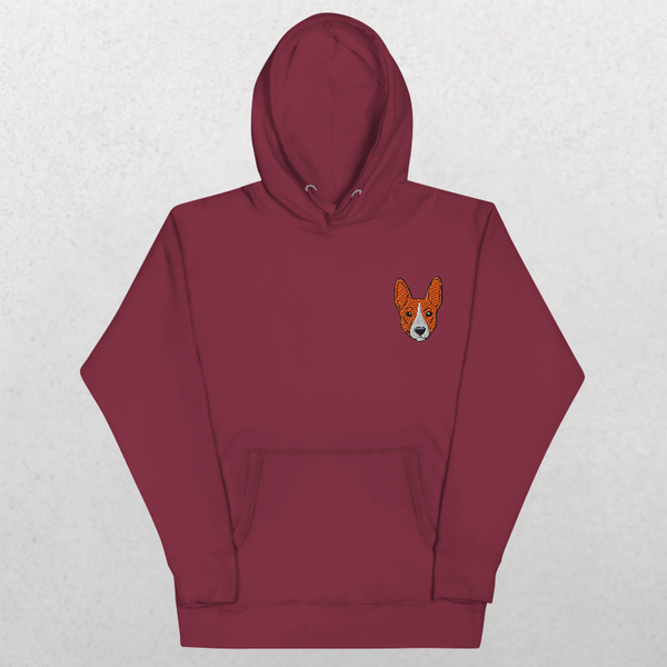 The Embroidered Custom Pet Hoodie in maroon features a small, orange and white dogs face on the left chest, shown on a light gray background—an ideal unique gift for pet lovers.
