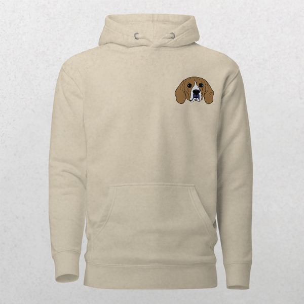 Embroidered Custom Pet Hoodie in beige, featuring a small cartoon brown and white dog’s face with long ears and a blue collar on the upper left chest—a cozy keepsake for pet lovers.