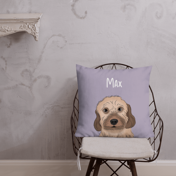 The Custom Cartoon Pet Cushion, featuring an illustrated dog and the name Max, sits on a chair against a light gray wall—an ideal cozy keepsake or unique pet memorial gift.