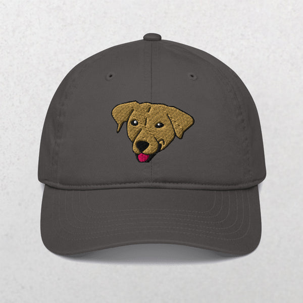 The Embroidered Pet Portrait Organic Classic Dad Cap in charcoal features a brown dog’s face with black eyes, a black nose, and a red tongue—making it an ideal custom dog dad cap or personalized pet gift.