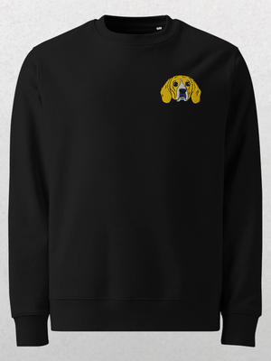 The Embroidered Pet Portrait Organic Sweatshirt in black showcases a small yellow and brown dog head embroidered on the left chest—an ideal personalized pet gift, pictured on a light textured background.
