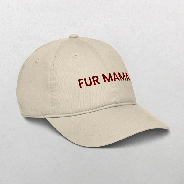 The Classic Organic Dad Cap - Furr Mama is a beige hat with FUR MAMA boldly embroidered in dark red on the front, displayed on a light, textured surface.