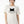 A woman in the Tiny Furry Overlord t-shirt, featuring a black cat face and the phrase MY Life is Ruled By a Tiny, Furry Overlord, stands against a plain white background—a hilarious pet tee for any cat lover.