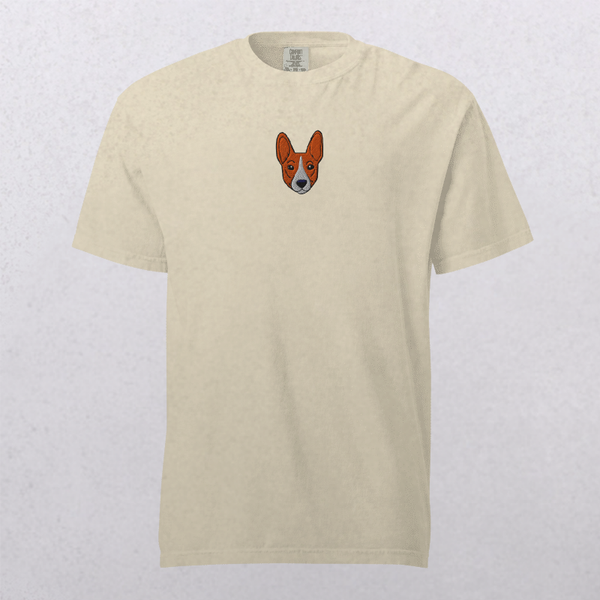 The Embroidered Pet Portrait Organic T-Shirt is a vintage-style beige top with a small cartoon corgi dog face embroidered on the left chest, shown against a light textured background.
