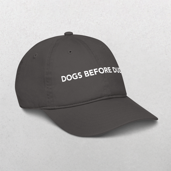 The Classic Organic Dad Cap - Dogs Before Dudes is a black embroidered cap featuring DOGS BEFORE DUDES in bold white letters, shown on a light gray background. A perfect stylish gift for any dog dad.