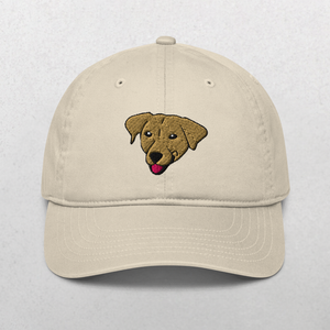 The Embroidered Pet Portrait Organic Classic Dad Cap in oyster features a brown dogs face with its tongue out, embroidered on the front—an ideal personalized pet gift for dog dads.