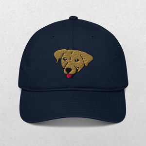 The Embroidered Pet Portrait Organic Classic Dad Cap in Pacific features an embroidered tan dog face with its tongue out, centered on the front. This unique cap is a perfect personalized pet keepsake or gift. Shown on a plain, light background.