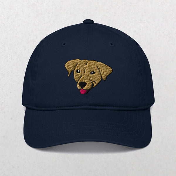 The Embroidered Pet Portrait Organic Classic Dad Cap in Pacific features an embroidered tan dog face with its tongue out, centered on the front. This unique cap is a perfect personalized pet keepsake or gift. Shown on a plain, light background.
