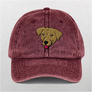 The Custom Pet Portrait Embroidered Vintage Cap is a maroon distressed cap featuring an embroidered brown dog’s head with its tongue out—a perfect personalized pet gift.