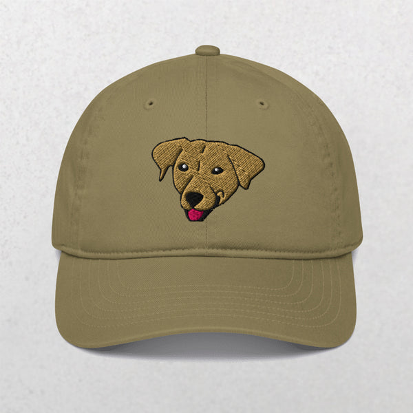 The Embroidered Pet Portrait Organic Classic Dad Cap in Jungle features an embroidered brown dog’s head with its tongue out, centered on the front—a perfect personalized gift for any dog lover.