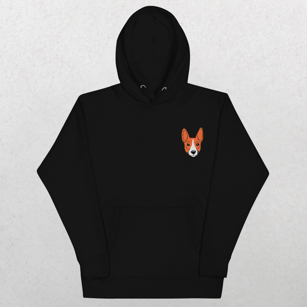 The Embroidered Custom Pet Hoodie in black features a small, cartoon-style orange and white dog face on the left chest, displayed on a light gray background—a cozy keepsake for any dog lover.