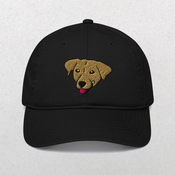 The Embroidered Pet Portrait Organic Classic Dad Cap in black features a tan dogs face with its tongue out, embroidered on the front—an ideal accessory for dog lovers.