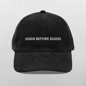 The Chord Vintage Cap - Dogs Before Dudes is a trendy black baseball hat with white DOGS BEFORE DUDES embroidery on the front, perfect for dog lovers.
