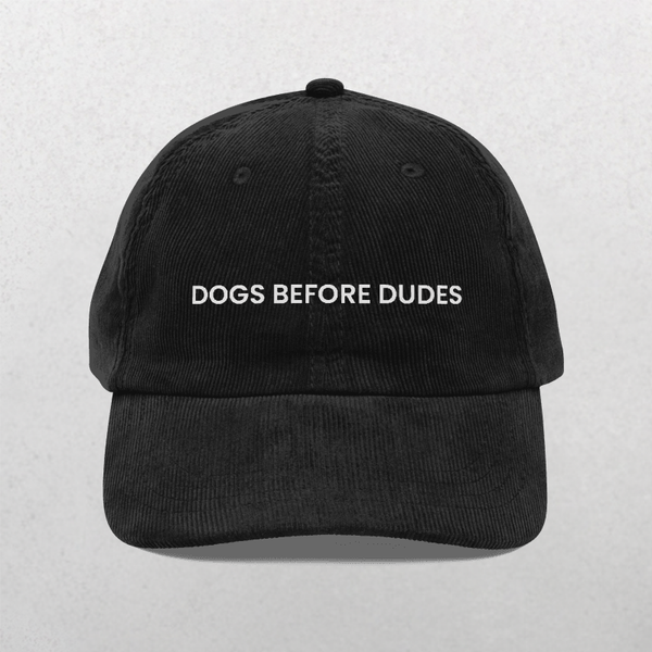 The Chord Vintage Cap - Dogs Before Dudes is a trendy black baseball hat with white DOGS BEFORE DUDES embroidery on the front, perfect for dog lovers.