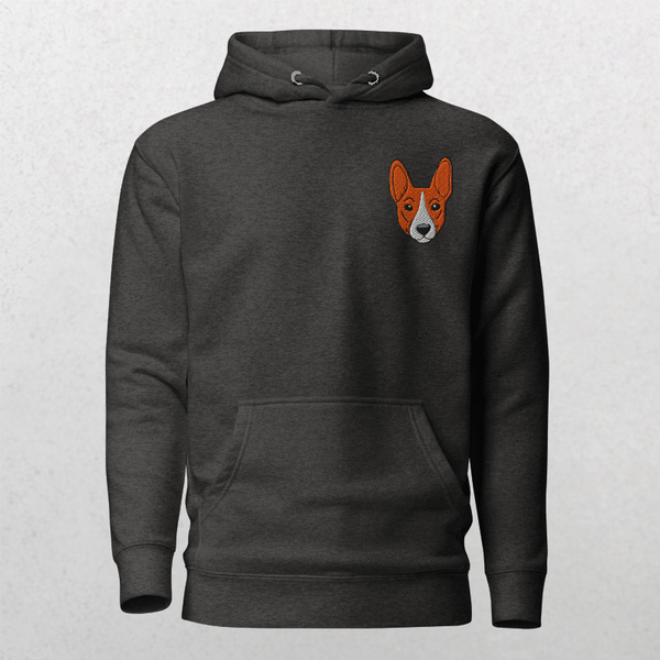 The Embroidered Custom Pet Hoodie features a dark gray vintage look, front pocket, and a small orange and white dog face embroidered on the left chest. Set against a light gray textured background—an ideal gift for pet lovers.