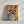 The Abstract Masterpiece - Custom Pet Portrait features your dog with big eyes and floppy ears on a vibrant abstract background of yellow, blue, red, and black—ideal minimalist pet artwork for white surfaces.