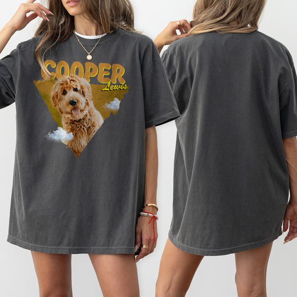 A woman wears an oversized dark gray Personalised Retro Tee | Orange, featuring a golden doodle dog with COOPER in bold yellow letters and Lewis below. The front displays the design; the back is plain—a perfect gift for pet lovers.