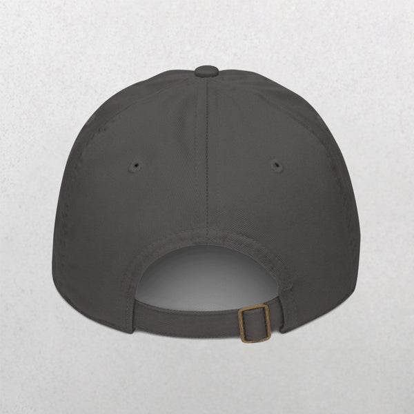 The Embroidered Line Art Pet Portrait Organic Classic Dad Cap is shown from the back, displaying a dark gray color, adjustable strap with metal buckle, and two side eyelets—ideal as a personalized pet gift on a light textured background.