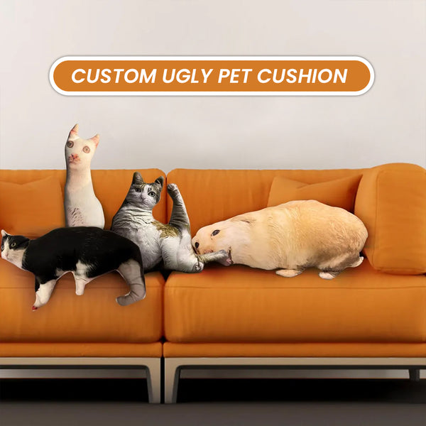 A vibrant orange couch displays four Custom Ugly Shape Pet Pillows, each resembling different animals. Above is a sign: CUSTOM UGLY PET CUSHION. These quirky pillows make a unique pet memorial gift for animal lovers.