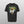 A grey Personalised Retro Tee | Green with a grumpy cat inside a green triangle, stylized yellow “DAISY” text above, “Halford” on the side, and cloud graphics near the triangle’s bottom.