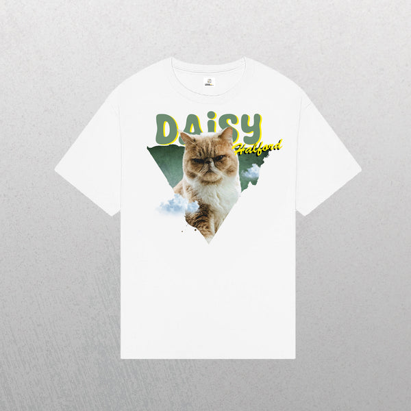 White Personalised Retro Tee | Green featuring a grumpy light brown cat in front of a green triangle, “DAISY” in yellow, “halboui” above the cat, with cloud details—a unique vintage-style white tee for pet lovers.
