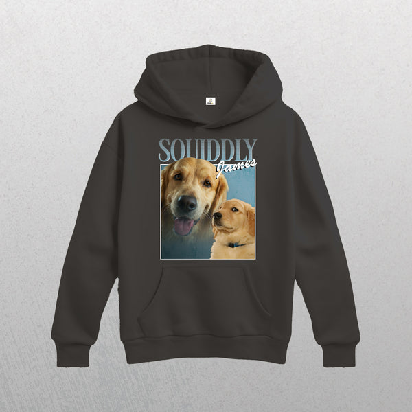 The Personalised Homage Hoodie | Ice in Gray is a premium unisex fleece featuring two golden retriever photos—one close-up with its tongue out and one profile view—beneath the SQUIDDLY James text in bold and script fonts.