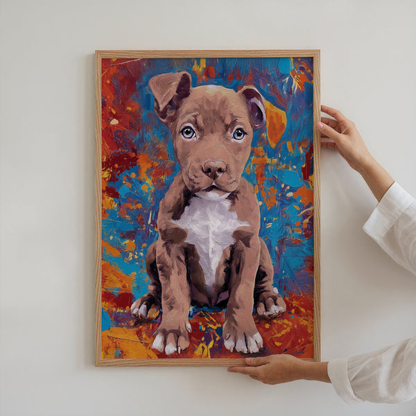 With the Oil Masterpiece - Custom Pet Portrait, a person hangs a framed painting of a brown puppy with a white chest on a vivid abstract background featuring blue, orange, and red splashes.