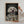 A person holds The Renaissance Duchess—a framed canvas featuring a white fluffy dog in royal attire, making a unique pet lover gift or a touching piece of pet memorial wall art.