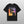 The Personalised Homage Tee | Cosmic is a black T-shirt with two pugs—one colorful, one black and white—beneath “REGGIE and Brown” on a vibrant gradient. A unique keepsake and perfect gift for pet lovers who cherish their furry friends.