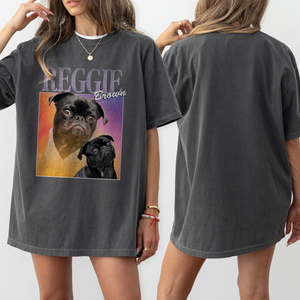 A woman wears the Personalised Homage Tee | Cosmic, a loose dark gray vintage shirt featuring a colorful graphic of two pugs and REGGIE Brown; both front and back views of this unique pet keepsake shirt are shown.