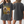 Two women wear oversized dark gray Personalised Homage Tee | Gold shirts; the front shows two fluffy dogs with RODNEY & Mabel—a custom dog shirt ideal for pet lovers. One woman faces forward displaying the graphic, the other shows the plain back.