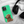 The Custom Pet iPhone Case – Modern Vector Art in green, featuring a golden retriever illustration and the name Snow, sits next to black headphones on a white, fluffy surface—an ideal keepsake for dog lovers.