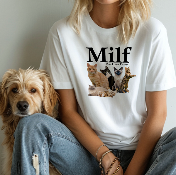A woman wears a white Milf vintage pet t-shirt with Man I Love Felines and six cat images, sitting next to a fluffy dog—perfect gift for pet lovers.