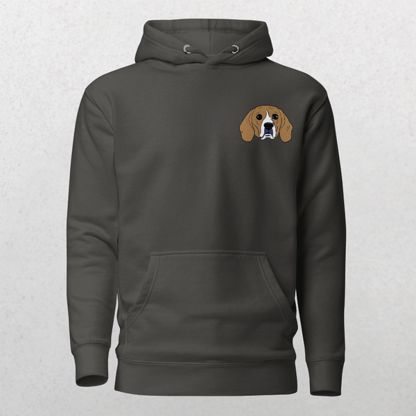 The Embroidered Custom Pet Hoodie is a dark gray hoodie with a small, cartoon-style beagle face embroidered on the left chest. Set against a light background, its the perfect cozy keepsake for any dog lover.